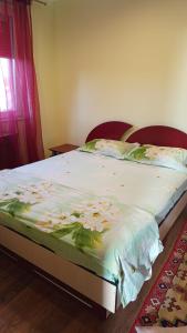 a large bed in a bedroom with at Harta in cui in Sighetu Marmaţiei