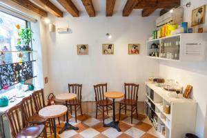 a kitchen with a table, chairs, and a refrigerator at Fujiyama B & B in Venice