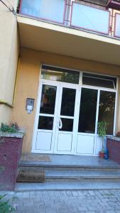 a white door of a building with a porch at Harta in cui in Sighetu Marmaţiei