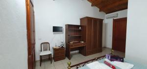 a bedroom with a bed and a desk and a chair at Bungalow Coronas in Bonorva +41 photos