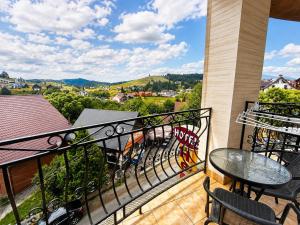 a balcony with tables and chairs and a view at SPA Resort HeRICH in Bukovel