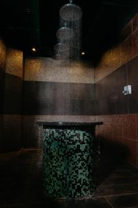 a bathroom with a fountain in the middle of a room at WestCord Hotel Eindhoven in Eindhoven