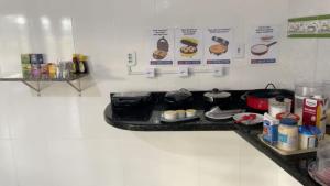 a kitchen with a counter with food on it at Delta Hotel Nova Mutum in Nova Mutum