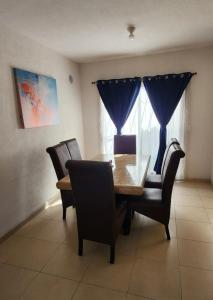 a dining room with a wooden table and chairs at Casa Misiones 1 in El Espino +9 photos