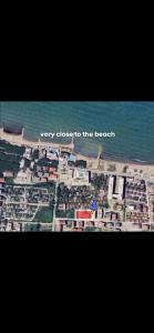 a picture of a beach with the words very close to the beach at Ibra apartament in Golem +3 photos