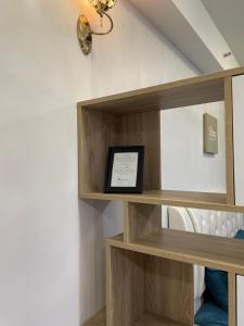 a shelf in a room with a picture on it at Crystal Studio Apartment D'Perdana in Kota Bharu +19 photos