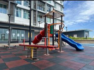 a playground with a slide and a slideintend at Crystal Studio Apartment D'Perdana in Kota Bharu