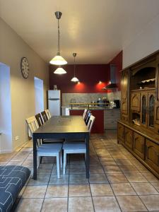 a kitchen and dining room with a table and chairs at L'estaou in Lavoûte-Chilhac