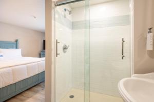 a bathroom with a shower and a bed at Blue Lobster Inn Cape Cod in Yarmouth +16 photos