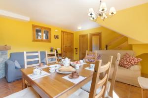a dining room with a wooden table and chairs at Casa Montenegro Las Colladas in Las Colladas +22 photos