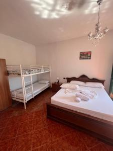 a bedroom with two bunk beds and a chandelier at Agron S in Vlorë