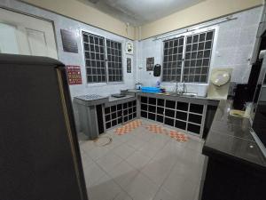 a small kitchen with a sink and a counter at AymanSyahir in Mukah