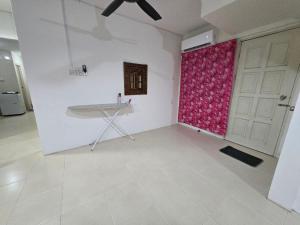 a living room with a table and a red window at AymanSyahir in Mukah