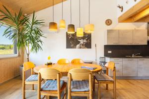 a kitchen and dining room with a wooden table and chairs at Hubertus in Dietingen