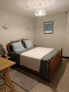a bedroom with a large bed in a room at Un air de campagne climatisé - Cure thermale ou vacances in Saint-Loubouer