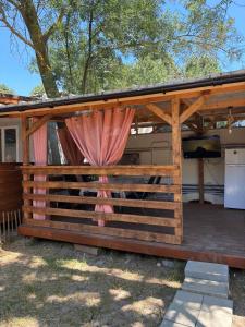 a wooden pergola with a grill on a patio at Divoto Zove in Tsarevo