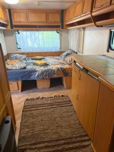 a small room with two beds and a kitchen at Divoto Zove in Tsarevo
