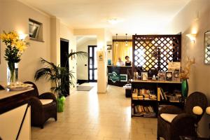 a room with a hair salon with a woman in the background at Hotel Marabel in SantʼAlessio Siculo