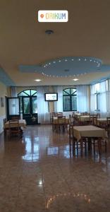 a dining room with tables and chairs in a building at Agron S in Vlorë