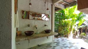 a bathroom with two bowls on a counter at Guarumbo in Bacalar