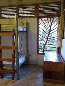 a room with bunk beds and a window at Guarumbo in Bacalar