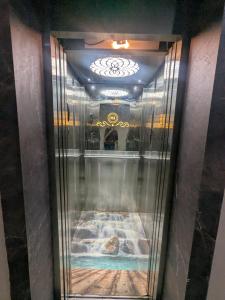 a elevator in a building with a painting on the wall at Hotel MJ in Ujjain