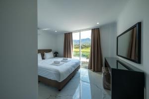 a bedroom with a bed and a large window at Atlantis Malibu by Carrington in Kyrenia +241 photos