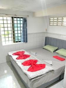 a bedroom with two beds with red towels on them at Home Frog Guesthouse in Phnom Penh