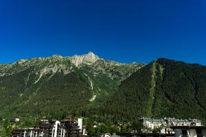 a view of a mountain range with a city at Hotel Le Morgane in Chamonix