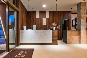 a lobby with a marble counter in a building at Taria Resort in Poreč +79 photos