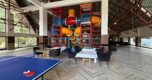 a dining room with a ping pong table and chairs at Serene Resorts Naran in Naran