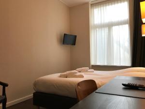 Postel nebo postele na pokoji v ubytování Hotel Carillon