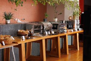 a coffee machine sitting on a wooden table at Hotel Colombo in Vila do Porto