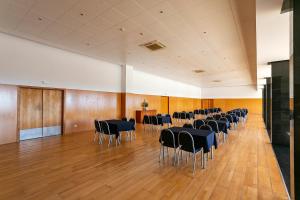 a large room with chairs and tables in it at Hotel Colombo in Vila do Porto