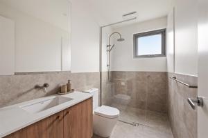 a bathroom with a toilet and a sink and a shower at The Cape Collective 5 in Margaret River Town +10 photos