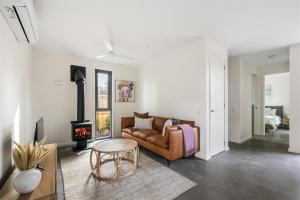 a living room with a couch and a fireplace at The Cape Collective 5 in Margaret River Town