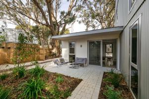 a house with a patio with two chairs at The Cape Collective 5 in Margaret River Town