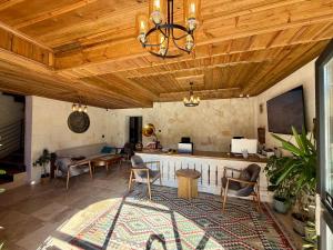 a living room with wooden ceilings and a table and chairs at Soho Cappadocia in Göreme