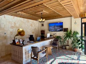 an office with a desk and a tv on the wall at Soho Cappadocia in Göreme