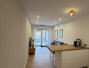 a kitchen and living room with a table and a couch at Herberg de Smederij in Kampen +7 photos