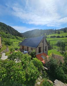 a house with solar panels on it in a field at La Parenthèse Enchantée Chalet in Beuil