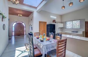 a kitchen and dining room with a table and chairs at TAJ VILLA Mahabaleshwar in Mahabaleshwar