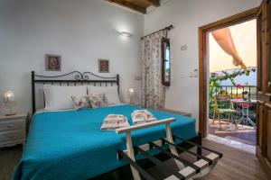 a bedroom with a blue bed and a balcony at Medieval Inn in Rhodes Town