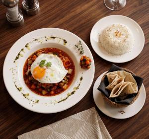 a plate of food with an egg and rice on a table at Home Frog Guesthouse in Phnom Penh
