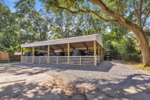 a house with a pavilion under a tree at The Porter Chamber in Ocean Springs