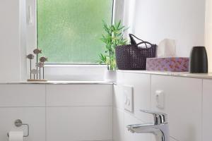 a bathroom with a sink and a window at Lärche in Sprakensehl +24 photos