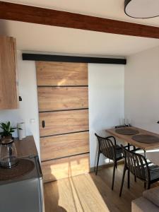 a kitchen and dining room with a sliding door at Noclegi nad jeziorem in Wiartel Mały +18 photos