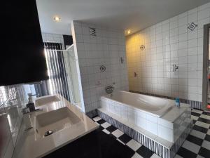 a bathroom with two sinks and a bath tub at logies 2460 in Kasterlee +6 photos