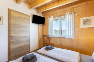 a bedroom with two beds and a window at Hubertus in Dietingen