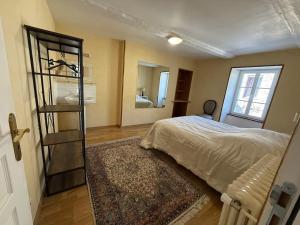 a bedroom with a bed and a book shelf at Le Cosy in Coutances